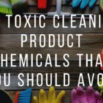 Various cleaning tools on a wooden surface with overlaid text: "10 Toxic Cleaning Product Chemicals That You Should Avoid.