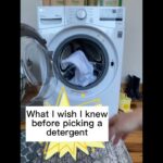 Front-loading washing machine with door open, clothes inside. Text overlay reads, "What I wish I knew before picking a detergent.