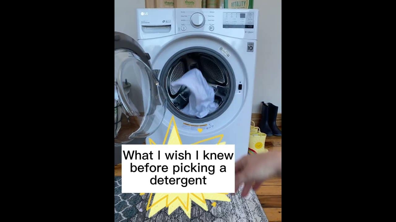 Front-loading washing machine with door open, clothes inside. Text overlay reads, "What I wish I knew before picking a detergent.